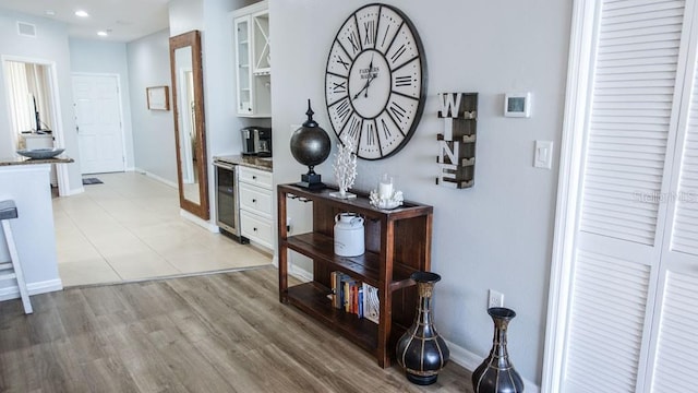 corridor with wine cooler and light tile floors