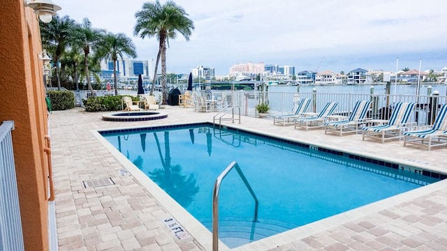 view of pool featuring a patio and a hot tub