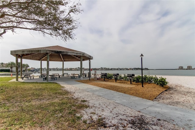 view of property's community with a water view and a gazebo