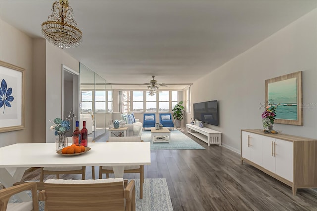 dining space featuring ceiling fan with notable chandelier and dark hardwood / wood-style flooring