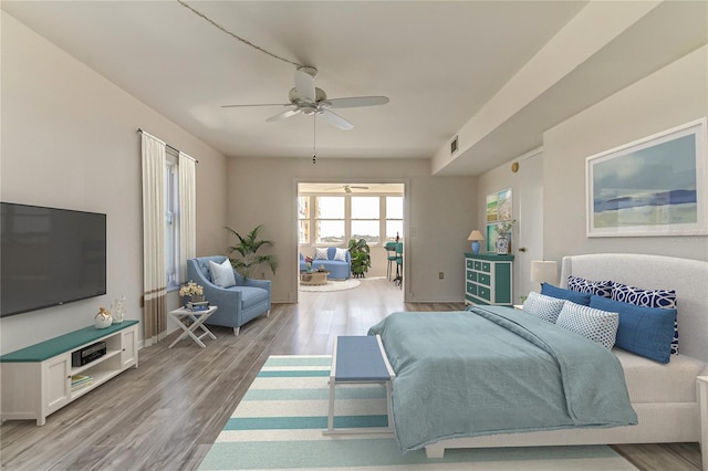 bedroom with wood-type flooring and ceiling fan