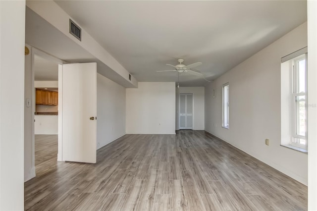 unfurnished room featuring visible vents, ceiling fan, and light wood finished floors