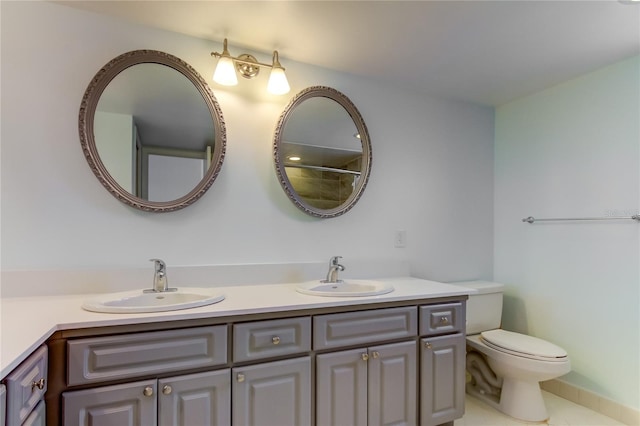 bathroom with a sink, toilet, and double vanity