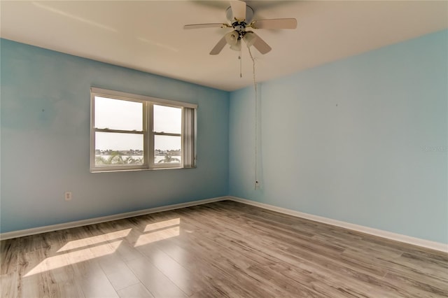 spare room with ceiling fan and light wood-type flooring