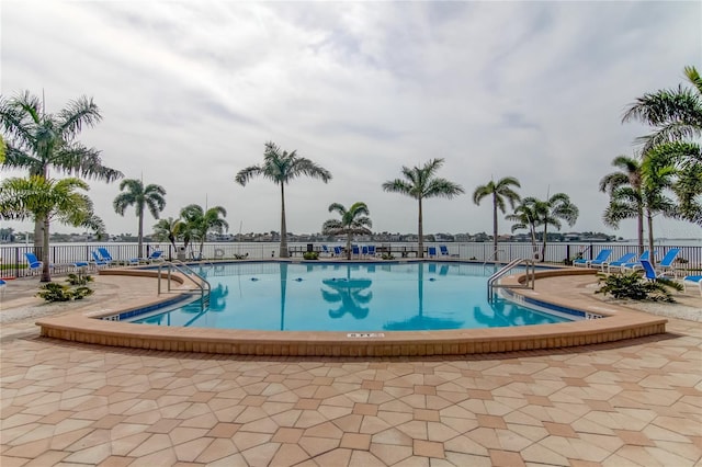 community pool featuring a patio area and fence