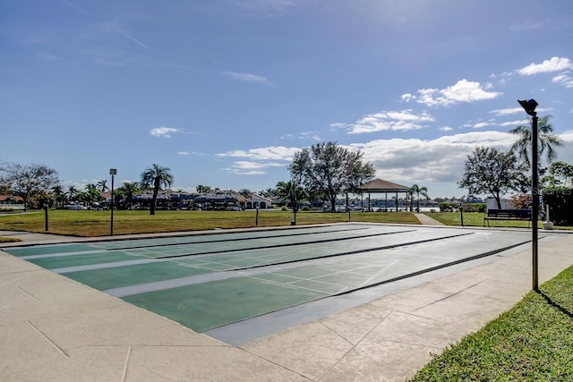 surrounding community with shuffleboard, a yard, and a gazebo