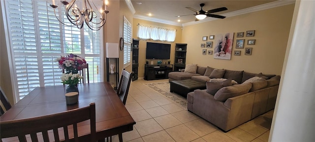 tiled living room with ceiling fan with notable chandelier and ornamental molding