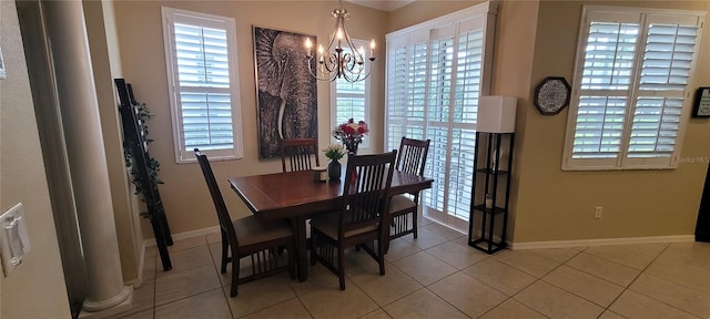 dining room with light tile floors, a healthy amount of sunlight, and a chandelier