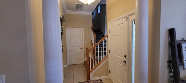 entrance foyer with ornamental molding and light tile flooring