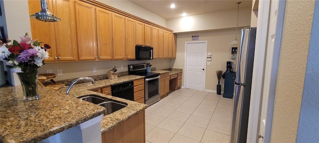 kitchen with black appliances, light tile flooring, sink, light stone counters, and pendant lighting