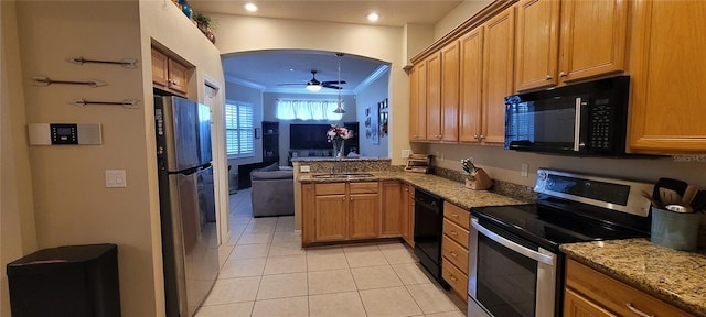 kitchen with kitchen peninsula, ceiling fan, crown molding, light stone countertops, and black appliances