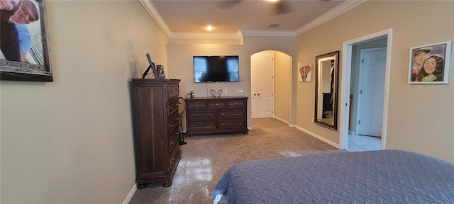 carpeted bedroom featuring ceiling fan and ornamental molding