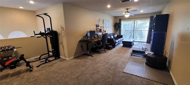 exercise area with light carpet and ceiling fan