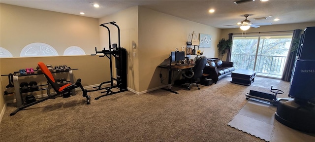 exercise area featuring light colored carpet and ceiling fan