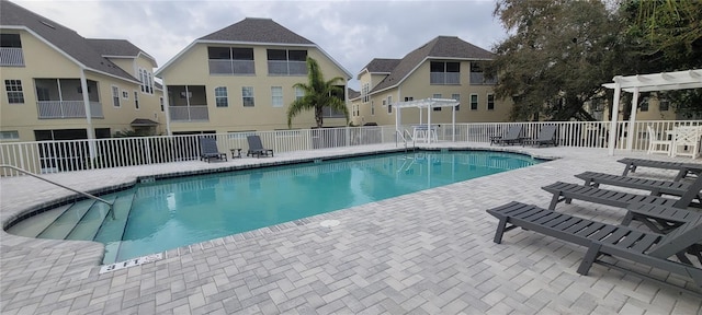 view of pool with a pergola and a patio area