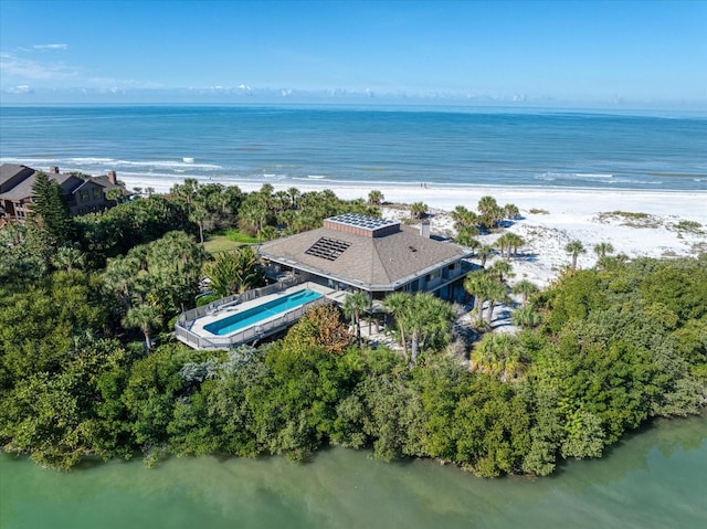 birds eye view of property with a water view and a view of the beach