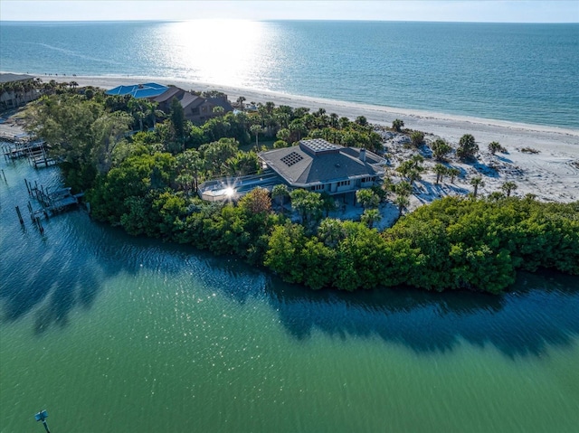 birds eye view of property with a water view and a view of the beach