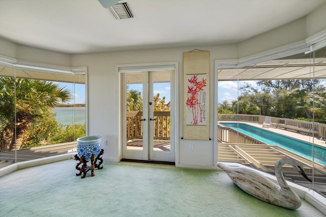 interior space with light colored carpet and french doors