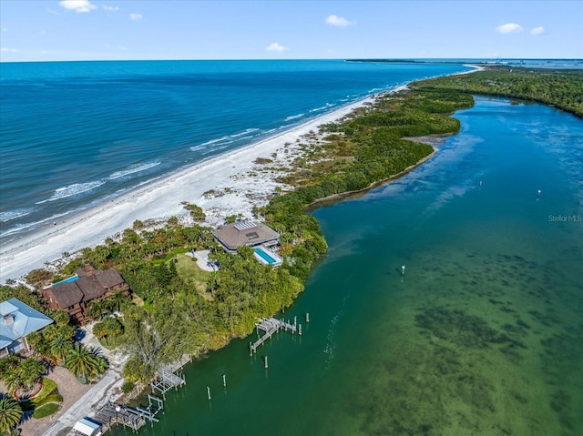 bird's eye view with a water view and a beach view