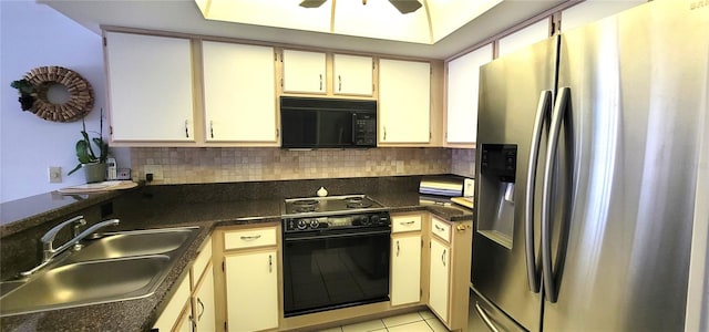 kitchen featuring cream cabinetry, light tile patterned floors, sink, and black appliances