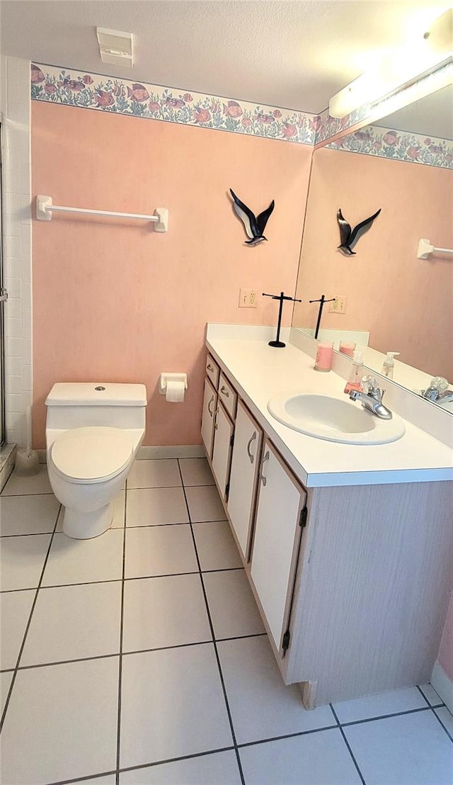 bathroom featuring tile patterned flooring, vanity, a textured ceiling, and toilet