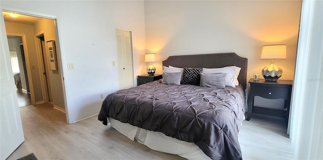 bedroom with a closet and light hardwood / wood-style flooring