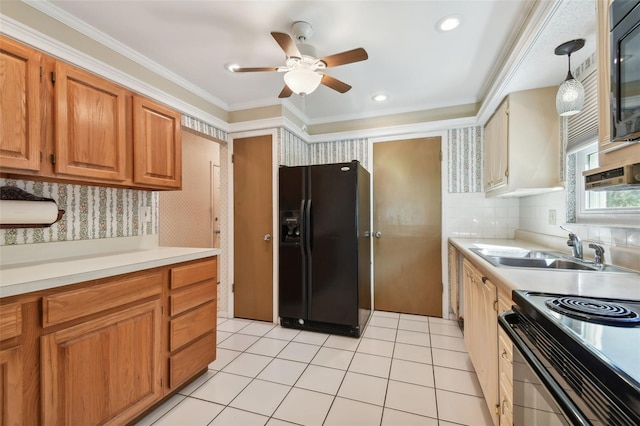 kitchen with pendant lighting, black appliances, sink, ceiling fan, and ornamental molding