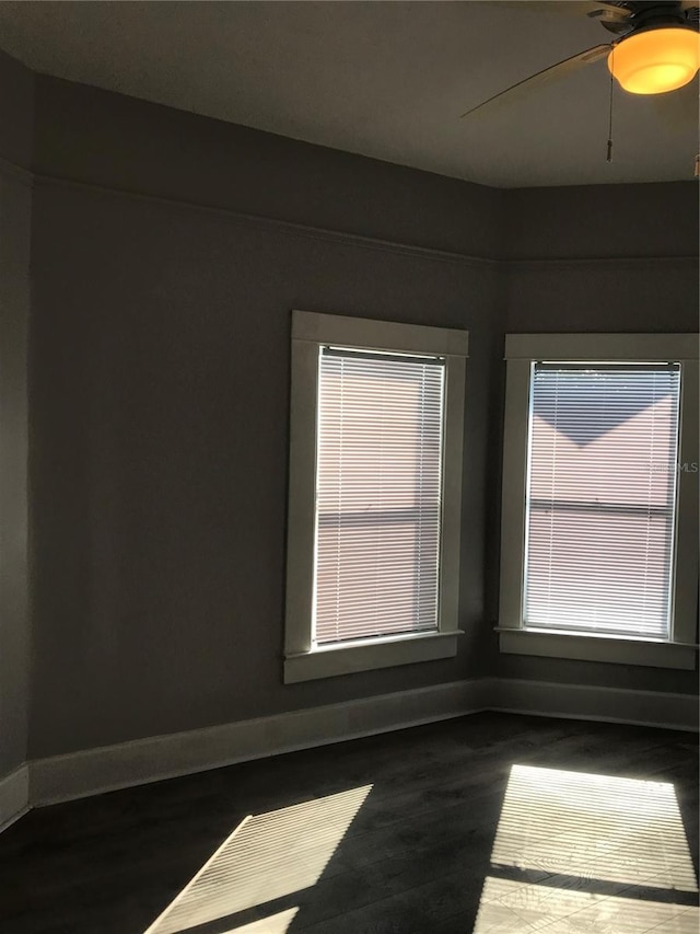 spare room featuring ceiling fan and dark hardwood / wood-style floors