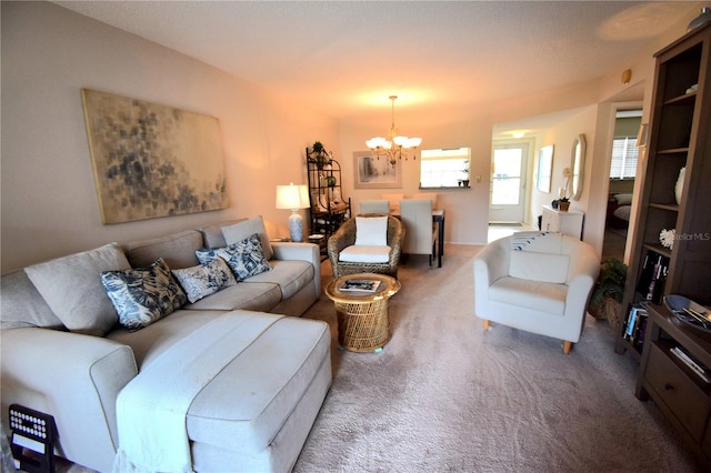 living room with a chandelier and dark colored carpet