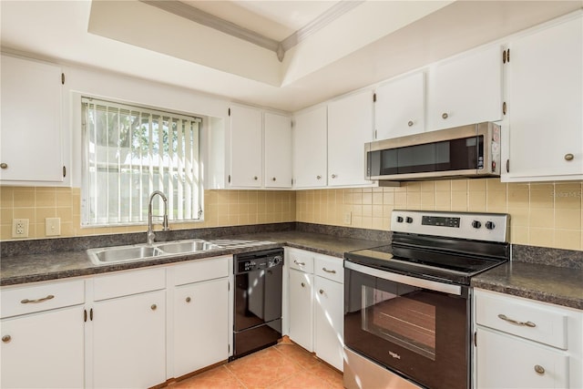 kitchen featuring stainless steel appliances, white cabinetry, sink, and tasteful backsplash