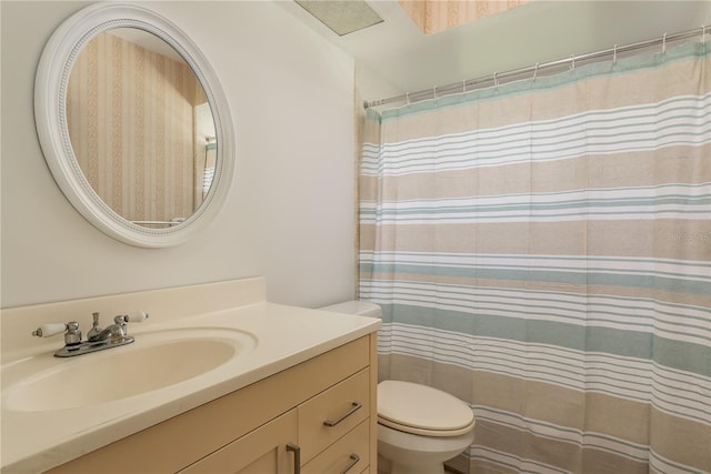 bathroom with vanity, toilet, and a shower with shower curtain