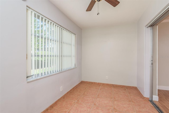 unfurnished room featuring light tile patterned flooring, ceiling fan, and a healthy amount of sunlight