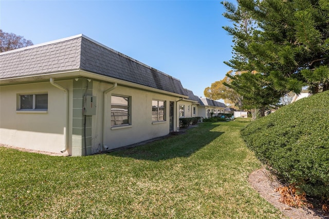 view of side of home featuring a lawn