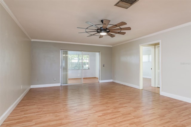 spare room with ornamental molding and light hardwood / wood-style flooring