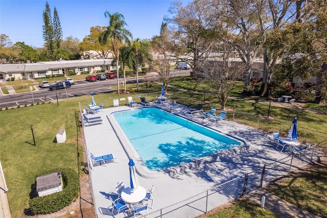 view of pool with a patio and a yard