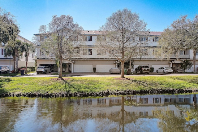 back of house with a water view and a garage