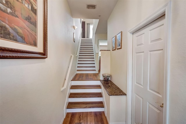 stairway featuring hardwood / wood-style flooring