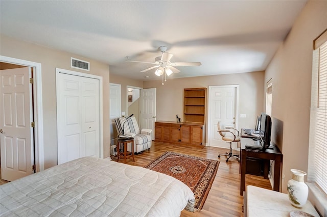 bedroom featuring light wood-type flooring, ceiling fan, and multiple windows