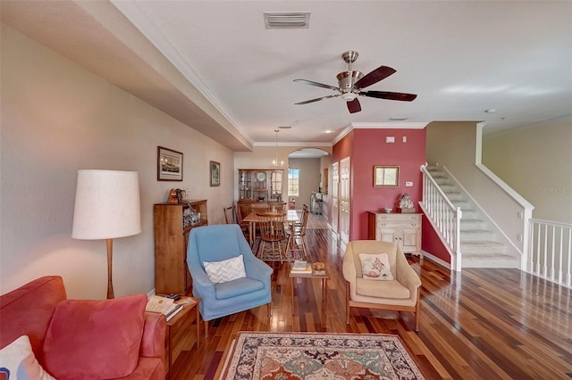 interior space featuring ceiling fan with notable chandelier, hardwood / wood-style floors, and ornamental molding