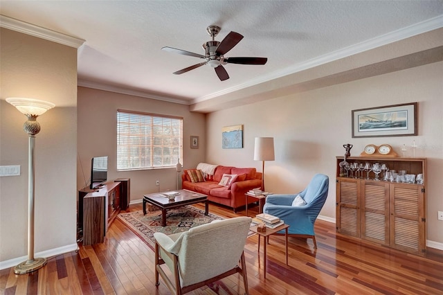 living room featuring ceiling fan, crown molding, wood-type flooring, and a textured ceiling