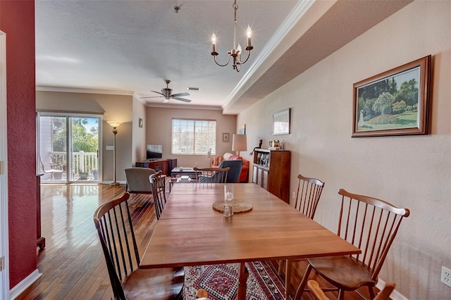 dining area featuring hardwood / wood-style flooring, ornamental molding, and a healthy amount of sunlight