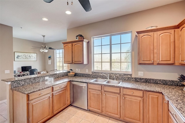 kitchen featuring light tile patterned floors, sink, dishwasher, ceiling fan, and kitchen peninsula