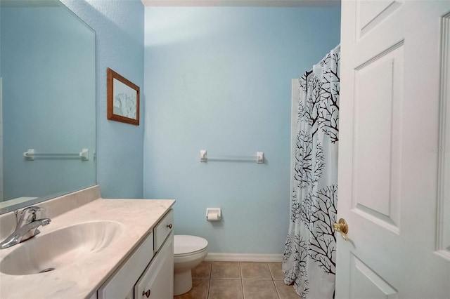 bathroom with tile patterned flooring, vanity, and toilet