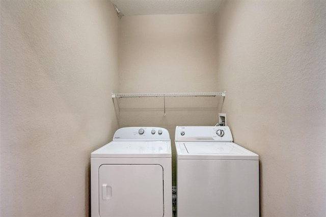 washroom featuring laundry area and washing machine and dryer