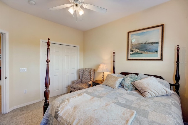 bedroom with light carpet, ceiling fan, baseboards, and a closet