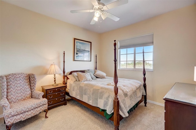 bedroom featuring light carpet, a ceiling fan, and baseboards