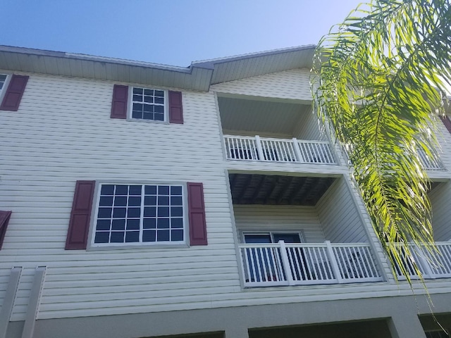 view of side of home featuring a balcony