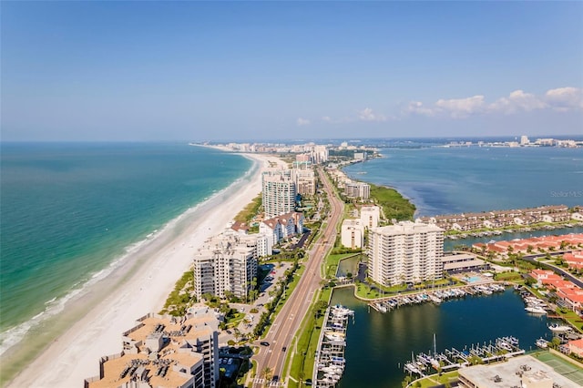 birds eye view of property with a beach view and a water view