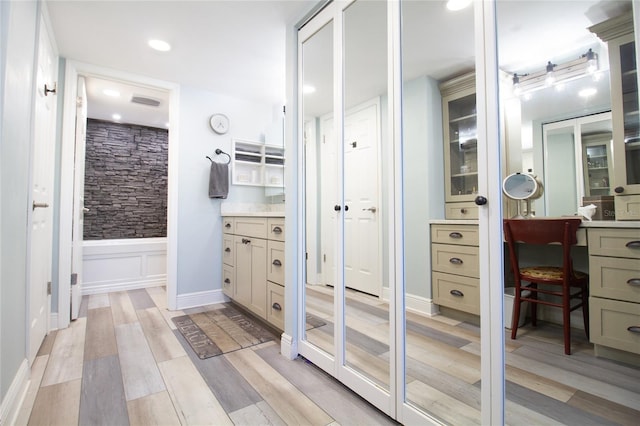 bathroom with hardwood / wood-style floors and vanity