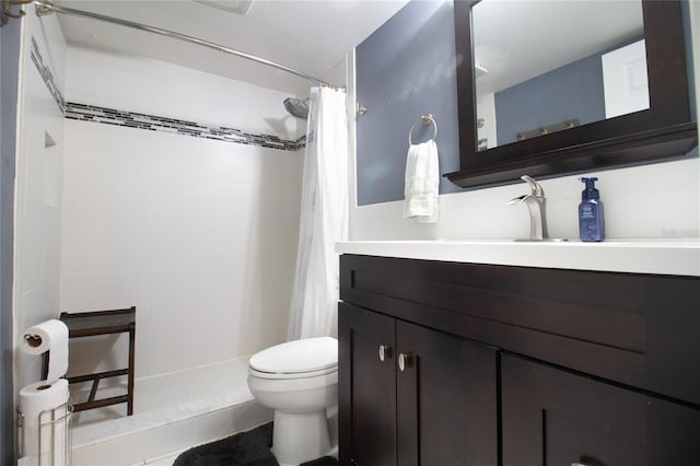 bathroom with tile floors, walk in shower, toilet, and vanity